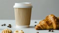 Aromatic coffee in a paper cup paired with a flaky croissant