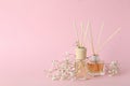 Aromatic concept with diffusers on pink background