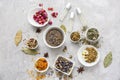 Aromatic dried flowers with herbs and essential oil on grey table