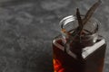 Aromatic homemade vanilla extract and dry pods on table, closeup. Space for text Royalty Free Stock Photo