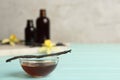 Aromatic homemade vanilla extract on blue wooden table. Space for text Royalty Free Stock Photo