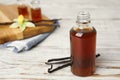 Aromatic homemade vanilla extract on wooden table. Space for text Royalty Free Stock Photo