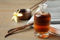 Aromatic homemade vanilla extract on wooden table, closeup. Space for text Royalty Free Stock Photo