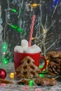 Aromatic hot winter cocoa drink with chewing marshmallows in a red cup with a straw, delicious gingerbread cookies, christmas Royalty Free Stock Photo