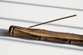 Aromatic incense stick in wooden holder on white background