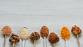 Aromatic Indian spices and herbs on metal spoons: star anise, fragrant pepper, cinnamon, asafoetida, turmeric. Spices texture Royalty Free Stock Photo