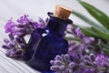 Aromatic lavender oil and beautiful flowers on the wooden