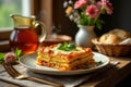 Aromatic layers of melted cheese and savory tomato sauce adorn this delicious pasta dish, served on a rustic table setting with Royalty Free Stock Photo