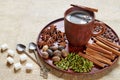 Aromatic masala tea with various spices on the brown plate: cinnamon, nutmeg, cardamom, anise stars. Aromatic coffee Royalty Free Stock Photo