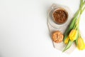 Aromatic morning coffee, cookies and beautiful flowers on white table, flat lay. Space for text