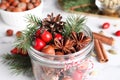 Aromatic potpourri in glass jar on white table, closeup