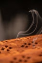 Aromatic smoke coming from natural wooden box with holes used for spiritual ceremonies, relaxation Royalty Free Stock Photo