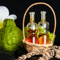 Aromatic spa concept of bottles essential oil in basket, flower, Royalty Free Stock Photo