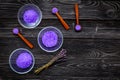 Aromatic spa cosmetics. Lavender violet spa salt on dark wooden background top view copy space