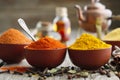 Aromatic spices: red chili pepper, turmeric, curcuma, cardamom, cloves, anise, paprika, oil bottles and teapot. Royalty Free Stock Photo