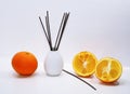 Aromatic sticks for home in white ceramic vase. Royalty Free Stock Photo