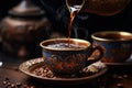 Aromatic Turkish coffee pouring from cezve into a decorated cup Royalty Free Stock Photo