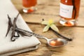 Aromatic vanilla extract and beans on wooden table Royalty Free Stock Photo