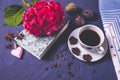 Aromaton coffee, book and pink hydrangea pieces of dark chocolate and three figs Royalty Free Stock Photo