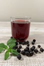 Aronia Berry Juice and mint on wooden table Royalty Free Stock Photo