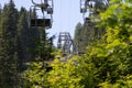 Arosa, Switzerland, August 15, 2021 Chair lift overhead some trees