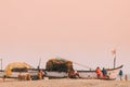 Arossim, Goa, India. Fishermen Pull Boat On Shore In The End Of Working Day At Sunset Time Royalty Free Stock Photo