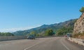 Around the bend - Sunshine on Spanish coastal highway. Foothills and mountain ranges on the edges of continental Europe in Spain. Royalty Free Stock Photo