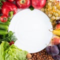 Around the white plate are ripe vegetables and fruits, nuts. The concept of proper nutrition Royalty Free Stock Photo