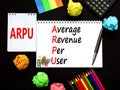 ARPU average revenue per user symbol. Concept words ARPU average revenue per user on white note on beautiful black background.