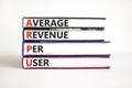 ARPU average revenue per user symbol. Concept words ARPU average revenue per user on books on beautiful white table white