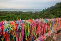 Arraial Dajuda, Bahia, Brazil: colorful souvenir ribbons hanging on the railing, sea on background