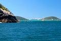 ARRAIAL DO CABO, RIO DE JANEIRO, BRAZIL- MARCH 21, 2016: Sailboat and a boat over a green and clear waters near a coast.