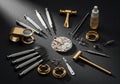 Is arranged around a partially disassembled watch movement on a dark Royalty Free Stock Photo