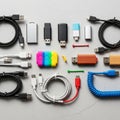 Arranged collection of USB cables and flash drives on a textured grey Royalty Free Stock Photo