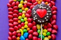 Arranged colorful sweets with chocolate heart lollipop