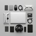 A silver laptop, black over-ear headphones, a wireless mouse, Royalty Free Stock Photo