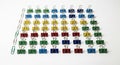 Arranged in a grid pattern, colorful binder clips form a neat square on a white surface. The clips Royalty Free Stock Photo