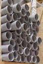 Arranged heap plastic pipes, grey shelf sold store