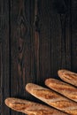 arranged loafs of french baguette on wooden surface
