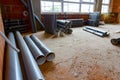 Pile of sewerage tubes placed on the floor in the unfinished residential edifice