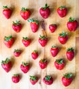 Arranged pattern of strawberries on a wooden board