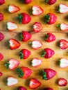 Arranged pattern of strawberries on a wooden board