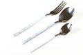 Arranged set of silver fork and two spoons on a white background Royalty Free Stock Photo