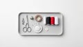 Arranged sewing kit on a rectangular tray features scissors a needle Royalty Free Stock Photo