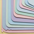 Arranged stack of layered pastel colored paper sheets with rounded Royalty Free Stock Photo