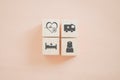 Arranged wooden cube block with health and medical icon on sweet orange background