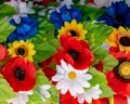 Arrangement bouquet poppies, daisies, sunflowers, green leaves closeup