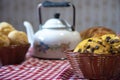 Arrangement with breads, sweets and teapot on a red and white towel Royalty Free Stock Photo