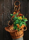 Arrangement with bright artificial flowers nestled in a wicker basket. Royalty Free Stock Photo