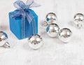 Arrangement with bue gift box and silver baubles Royalty Free Stock Photo